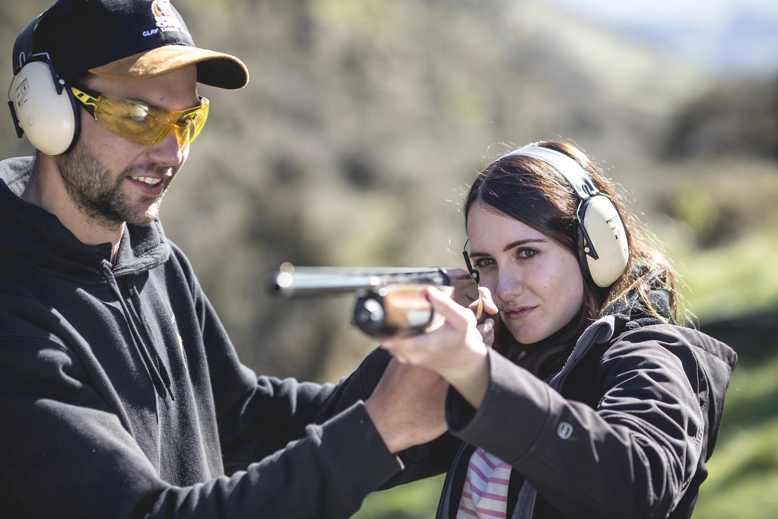 Instructor guiding a guest during a clay target shooting session at Break One Clay Target Experience in Queenstown, ensuring a safe and fun experience for all skill levels.