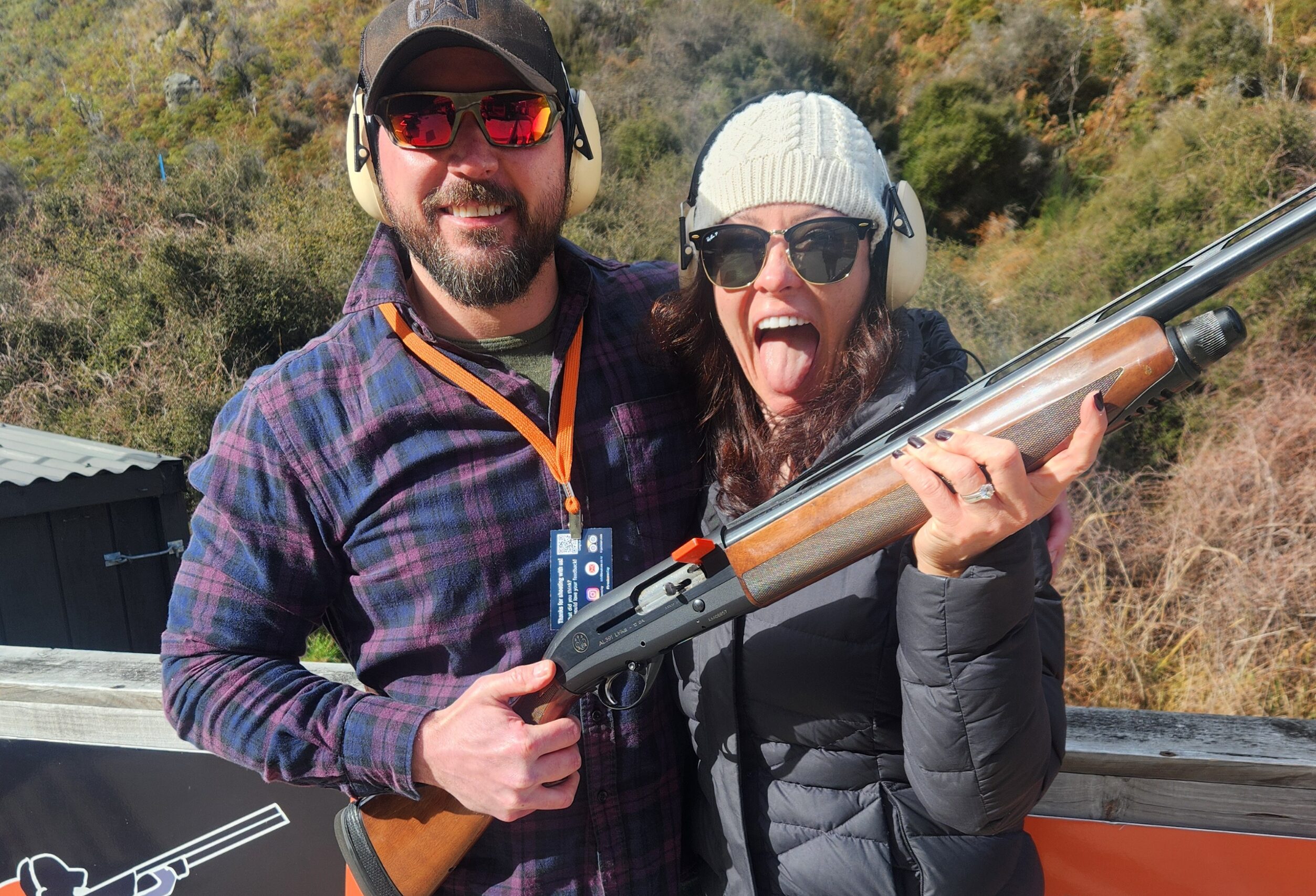 Man and woman aiming a shotgun during a clay target shooting session at Break One Clay Target Experience in Queenstown.