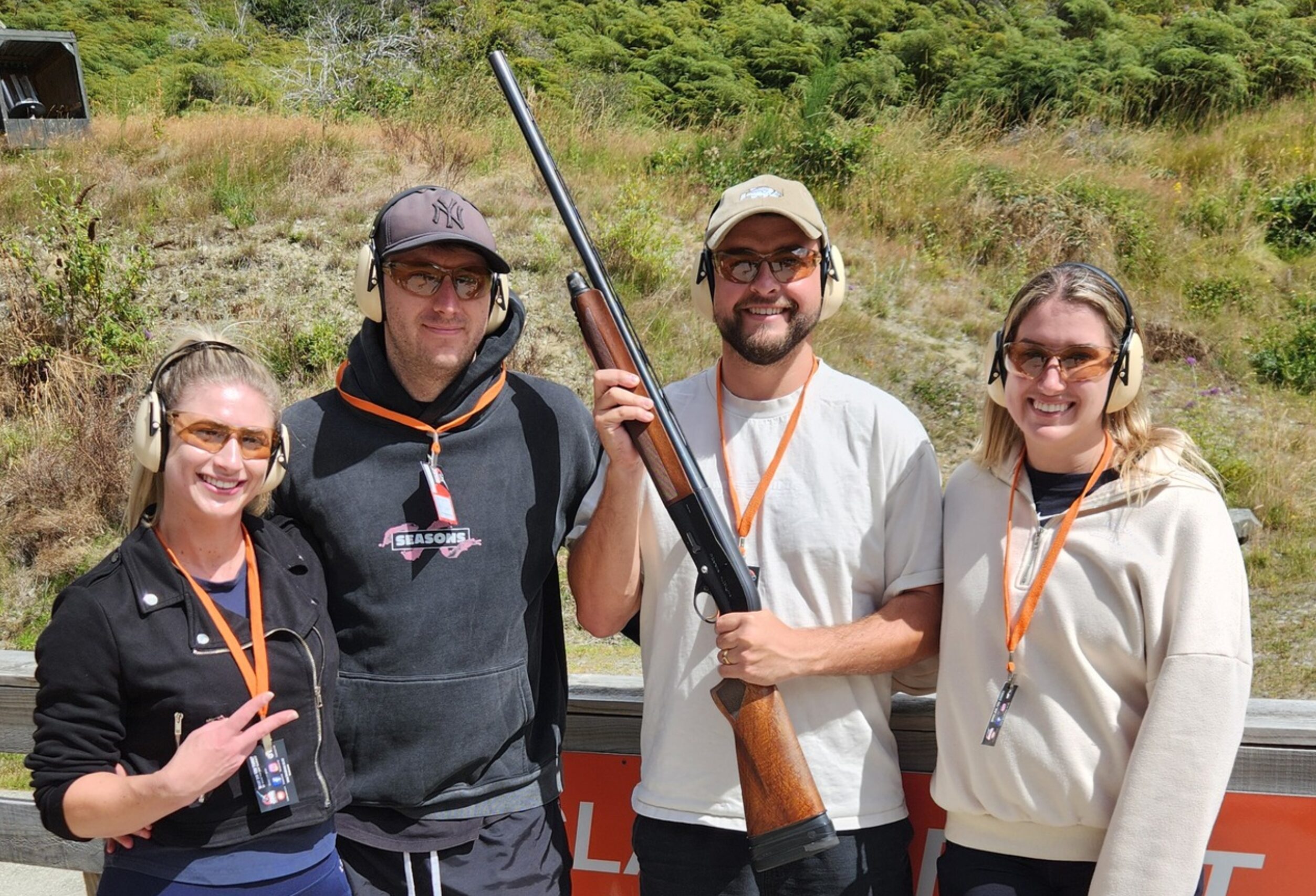 GGroup of friends posing with shotguns at Break One Clay Target Experience in Queenstown, enjoying a fun and safe shooting session for all skill levels.