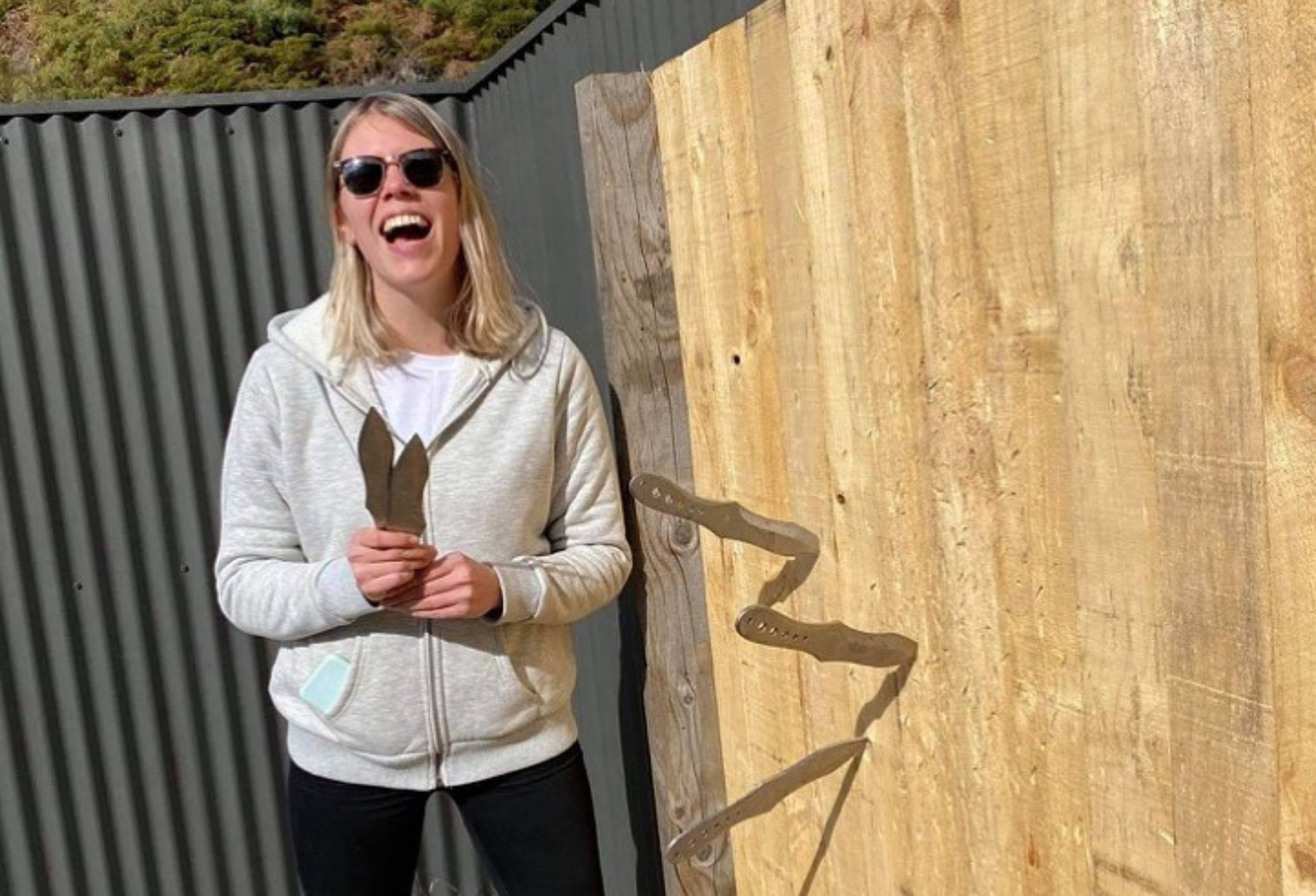Guest aiming and throwing a knife at a target during The Full Monty adventure experience near Queenstown.