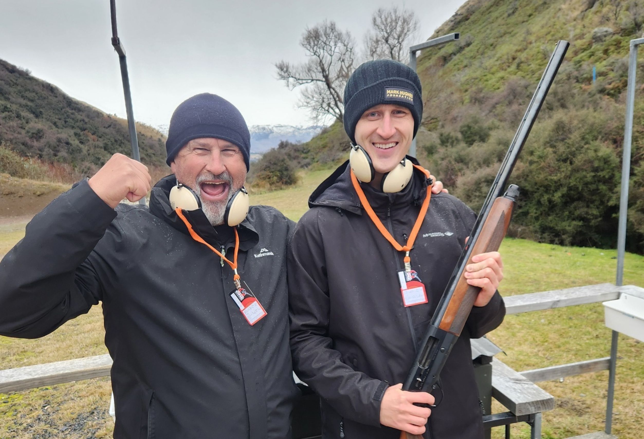 Two male guests smiling and posing with shotguns after a clay target shooting session at Break One in Queenstown, enjoying a fun and safe experience for all abilities.