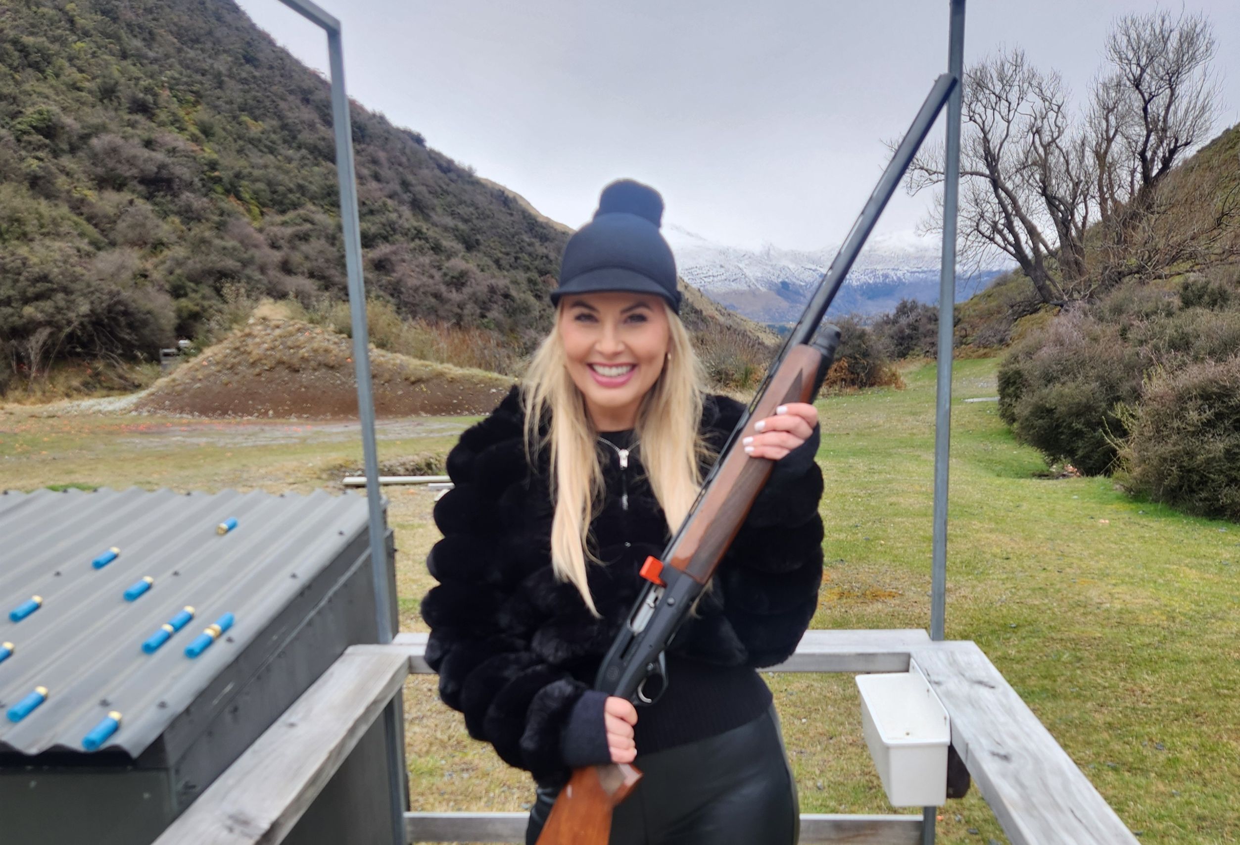 Female guest smiling after a clay target shooting session at Break One in Queenstown, enjoying a safe and fun experience suitable for all skill levels.